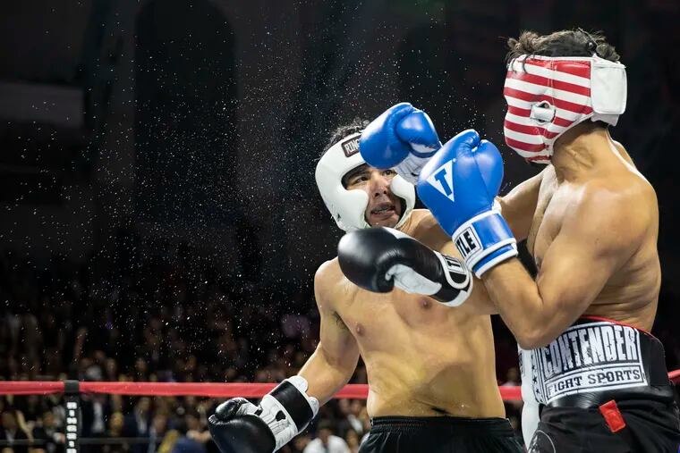 Mikhail Oza of Wharton and Dylan Lojac fight at the 15th annual Penn Fight Night at the Palestra on Saturday, March 23, 2019. The event is a charity boxing competition between the Penn graduate programs.