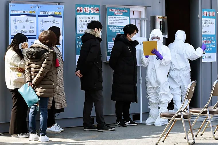 People suspected of being infected with the new coronavirus wait to receive tests at a medical center in Daegu, South Korea, Thursday, Feb. 20, 2020. The mayor of the South Korean city of Daegu urged its 2.5 million people on Thursday to refrain from going outside as cases of a new virus spiked and he pleaded for help from the central government.