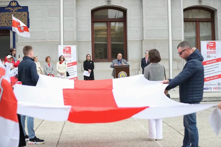 Councilmember David Oh speaks at a ceremony on Friday at which the 1918 red-and-white flag of Belarus, not the current red-and-green flag of the pro-Russia regime, was flown as a symbol of support for pro-democracy protesters in that nation.