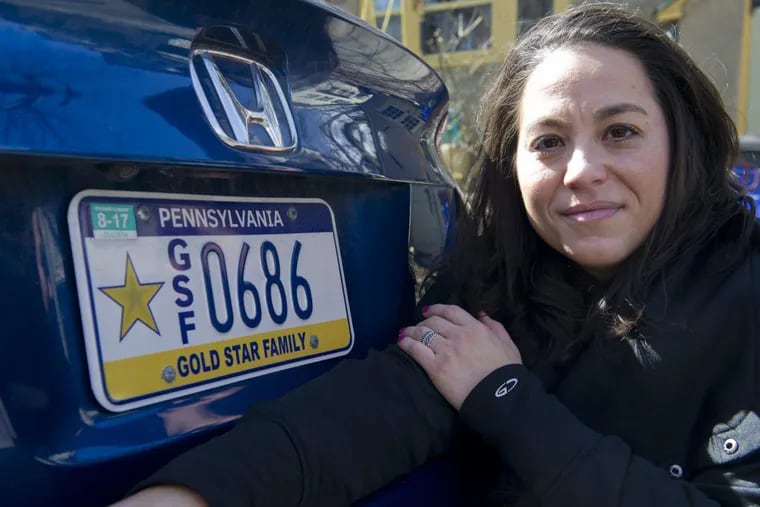Rachel Ascione, 36, next to her Gold Star Family license plate. Her brother, Cpl. Ron Payne Jr., was the first U.S. Marine killed in combat in Afghanistan, in 2004.