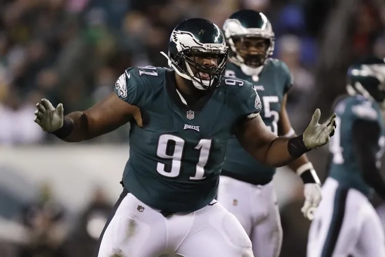 Eagles defensive tackle Fletcher Cox raises his arms against the Atlanta Falcons in a NFC Divisional Playoff game on Saturday, January 13, 2018 in Philadelphia. YONG KIM / Staff Photographer