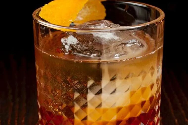 Escape Velocity with tobacco-infused Johnny Walker black, carpano antica, cherry heering and orange bitters as served at Charlie was a sinner., 131 S. 13th St., Philadelphia, October 2, 2014.  ( DAVID M WARREN / Staff Photographer )