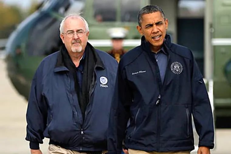 President Obama and Craig Fugate, administrator of the Federal Emergency Management Agency, walk from the Marine One helicopter, rear, before boarding Air Force One before their departure from Andrews Air Force Base, Md., on their way to New Jersey to see the relief efforts after Sandy. PABLO MARTINEZ MONSIVAIS / Associated Press
