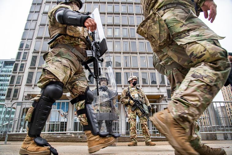 Members of the National Guard stand in guard in front of the Philadelphia Municipal Services Building in Philadelphia, Pa. Friday, October 31, 2020.