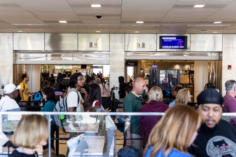 People wait in the TSA line at the Philadelphia International Airport on Thursday.