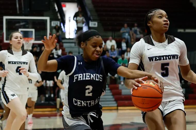 Friends’ Central’s Saniyah Washington (left) goes after the basketball against Westtown’s Savannah Curry.