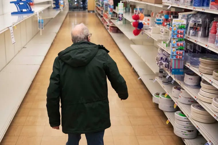 A shopper looks for toilet paper at a Stop & Shop supermarket during hours open daily only for seniors in North Providence, R.I.