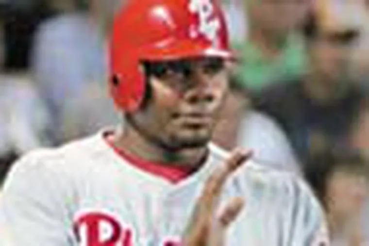 Philadelphia Phillies' Ryan Howard applauds teammates after scoring on a Carlos Ruiz single in the second inning against the Houston Astros in a baseball game Thursday, May 22, 2008, in Houston. (AP Photo/Pat Sullivan)