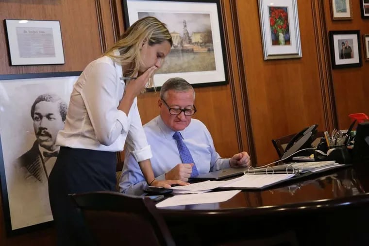 Mayor Kenney and Lauren Hitt, then his director of communications, talk in Kenney’s office at City Hall.
