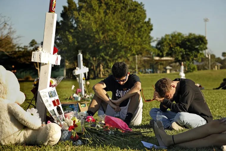 Students, friends, and family gathered at memorial crosses at Pine Trails Park in Parkland, Fla., to remember those killed and injured  at Marjory Stoneman Douglas High School.