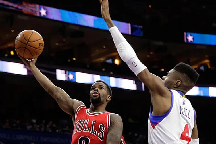 Chicago Bulls' Aaron Brooks (0) goes up for a shot as Philadelphia 76ers' Nerlens Noel (4) defends during the first half of an NBA basketball game, Wednesday, March 11, 2015, in Philadelphia. (Matt Slocum/AP)