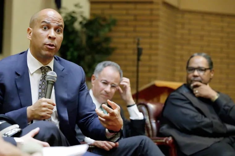 U.S. Sen. Cory Booker (from left), U.S. Attorney Paul Fishman and the Rev. William N. Heard of Kaighn Avenue Baptist Church during a panel discussion on criminal justice and mass incarceration at the Camden church on Aug. 4, 2016.