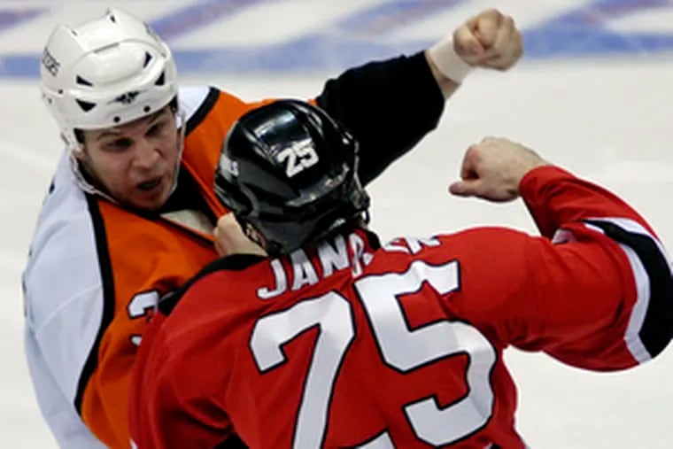 The Flyers&#0039; Riley Cote (left) tangles with New Jersey&#0039;s Cam Janssen in Philadelphia&#0039;s final appearance at the Continental Airlines Arena.