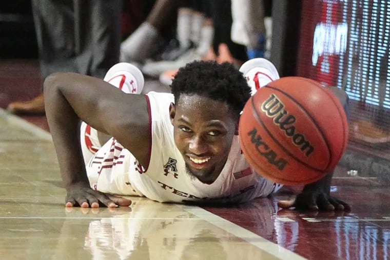 Shizz Alston of Temple is unable to get to a loose ball before it goes out of bounds against UMass.