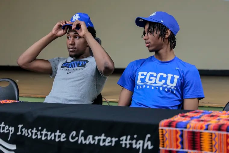 Imhotep Charter basketball players Justin Edwards (left) and Rahmir Barno before signing their national letters of intent to Kentucky and Florida Gulf Coast, respectively.