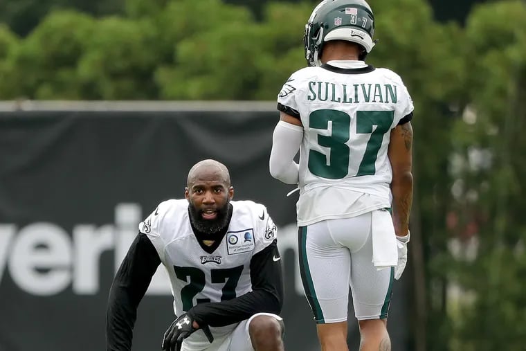 Eagles' Malcolm Jenkins, left, rests as Tre Sullivan, right, walks up during the Philadelphia Eagles training camp at the NovaCare Complex on July 27, 2018 in Philadelphia, PA. DAVID MAIALETTI / Staff Photographer