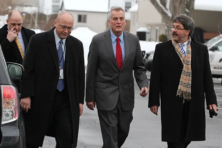 Don Tollefson, second from right, walks along with his lawyer, Michael McGovern, right, as he turns himself into Warminster Police Tuesday, Feburary 18, 2014. ( MICHAEL BRYANT / Staff Photographer )