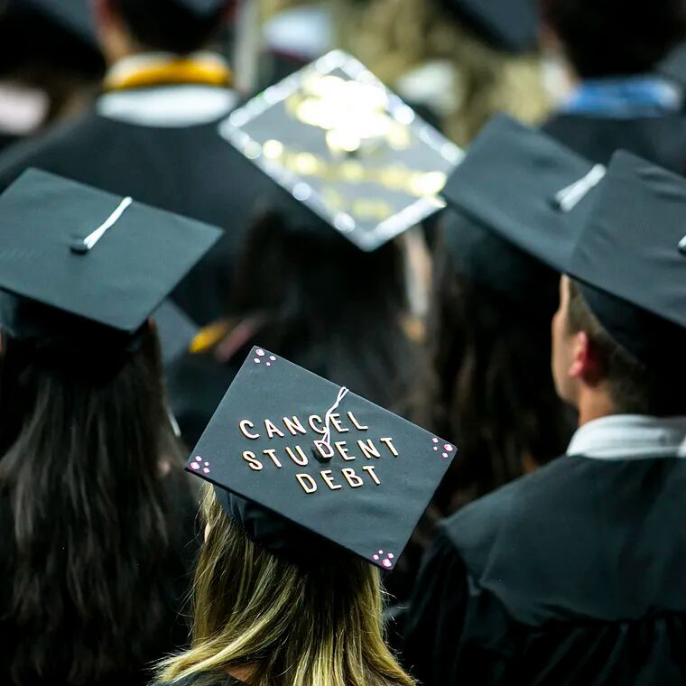 The cap of a University of Iowa graduates candidate is decorated with writing reading "Cancel student debt" during a commencement ceremony for the College of Liberal Arts and Sciences, Saturday, May 14, 2022.