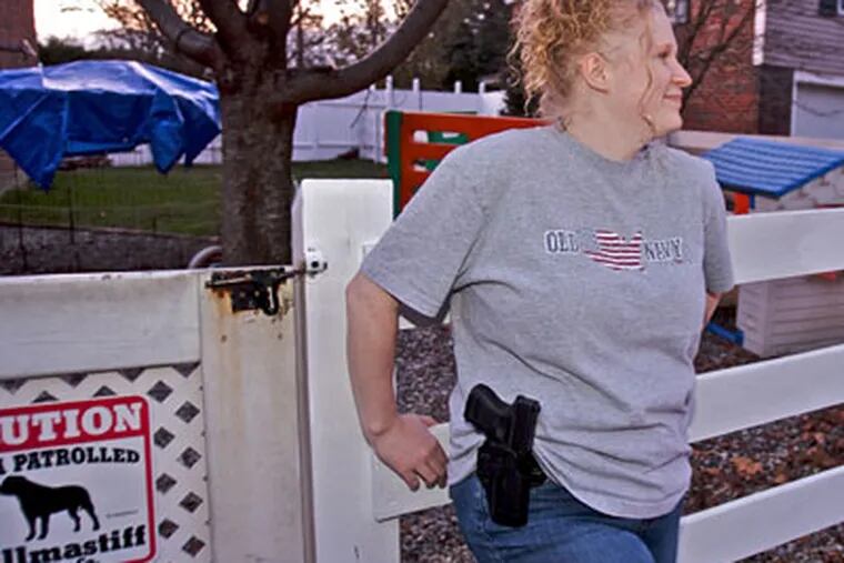 Meleanie Hain near her Lebanon, Pa., day-care with her Glock handgun holstered to her hip. (Staff Photographer / John Costello)
