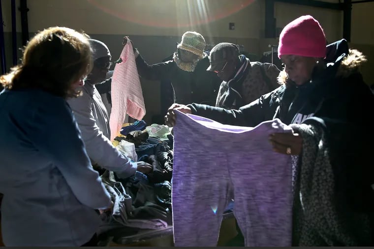 A group of women shop during the Our Closet pop-up clothing program for people in need at the Church of the Advocate in Philadelphia, PA on March 27, 2019.