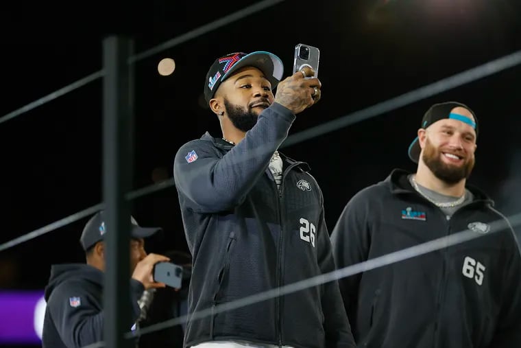 Eagles running back Miles Sanders makes videos of fans using his cell phone during the opening night of Super Bowl LVII festivities on Monday. On Friday, Sanders' newborn son arrived in Phoenix ahead of Sunday night's game.