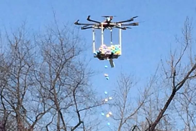 A drone drops candy-filled eggs outside Joyce Kilmer Elementary School in Cherry Hill, New Jersey on Saturday, March 26, 2016.