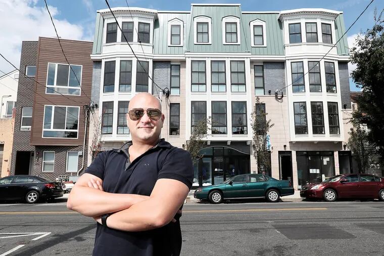 Amit Azoulay, a former art student, stands in front of his buidlign at 1512 Frankford in Fishtown, it is his design, overseen and fitted by architects.
