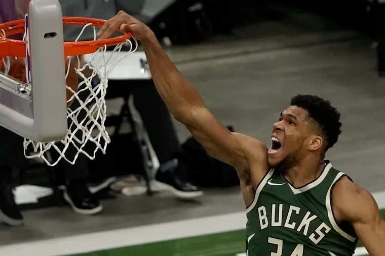 The Bucks' Giannis Antetokounmpo dunks during the third quarter against the Sixers.