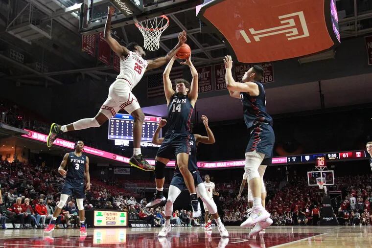 Jeremiah Williams, left,  of Temple  and Max Martz of Penn battle for a rebound during the 2nd half at the Liacouras Center on Dec. 4, 2021.