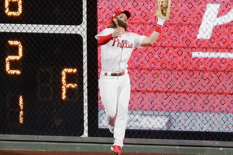Phillies right fielder Bryce Harper catches Adam Duvall's fourth-inning fly ball.