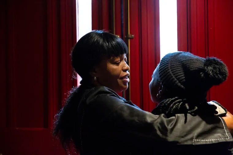 Oneita Thompson hugs her daughter Christine, who is 15, before she leaves for school inside the First United Methodist Church of Germantown on Monday, Nov. 12, 2018. Oneita Thompson and her husband, Clive, are from Jamaica and were living in South Jersey since 2004 before seeking sanctuary at the church. They live there along with Christine and Timothy, who is 12. HEATHER KHALIFA / Staff Photographer