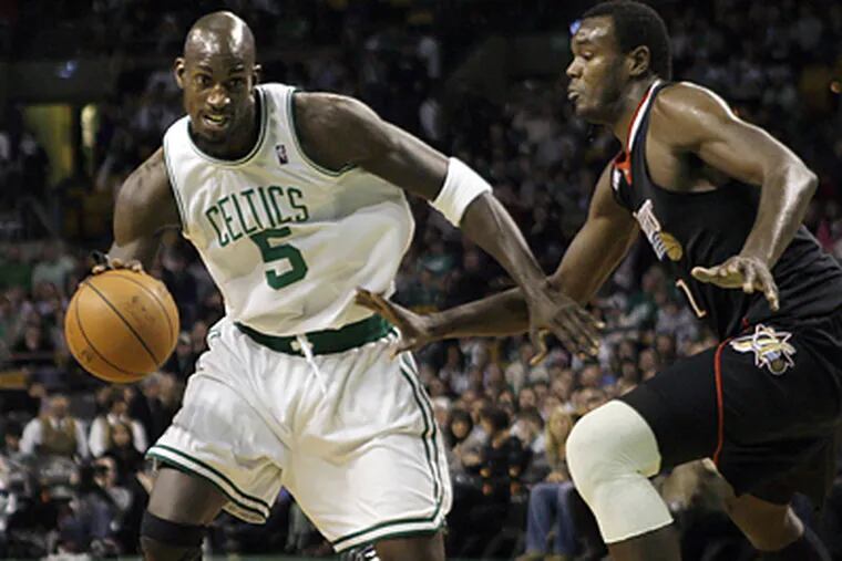 Kevin Garnett drives around the 76ers’ Samuel Dalembert. After helping Boston win a title last season, Garnett has helped the Celtics roll to a 27-2 start. (Elise Amendola/AP)