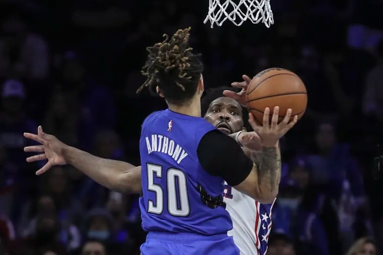 Sixers Joel Embiid blocks the shot of the Magic's Cole Anthony during the fourth quarter.