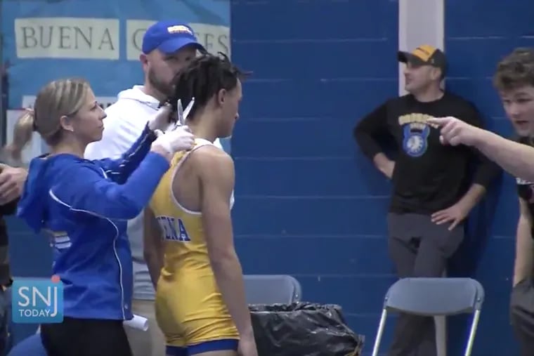 In a video captured by SJN Today News, Buena's Andrew Johnson stood stoically as his dreadlocks were shorn before he was allowed to compete against Oakcrest on Dec. 20.