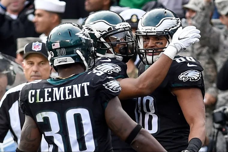 Eagles tight end Trey Burton (right), getting congratulated by teammates after scoring a touchdown in November.
