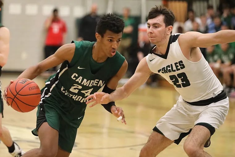 Camden Catholic's Kory Williams dribbles past West Deptford's Antonello Baggi in the fourth period.