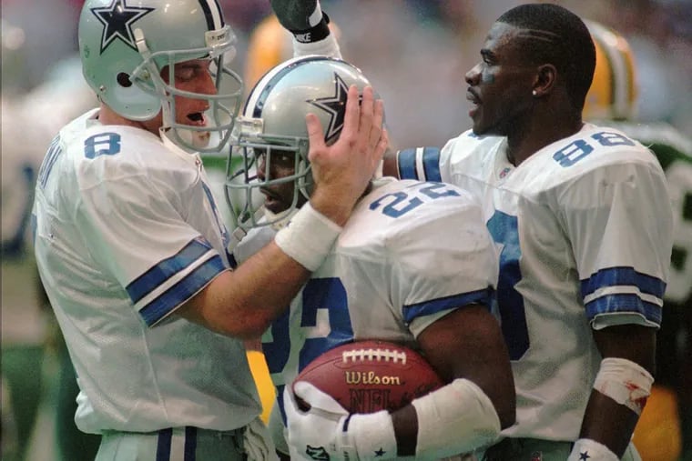 The Cowboys' Hall of Fame trio of Troy Aikman, Emmitt Smith and Michael Irvin celebrate during a victory in 1996.