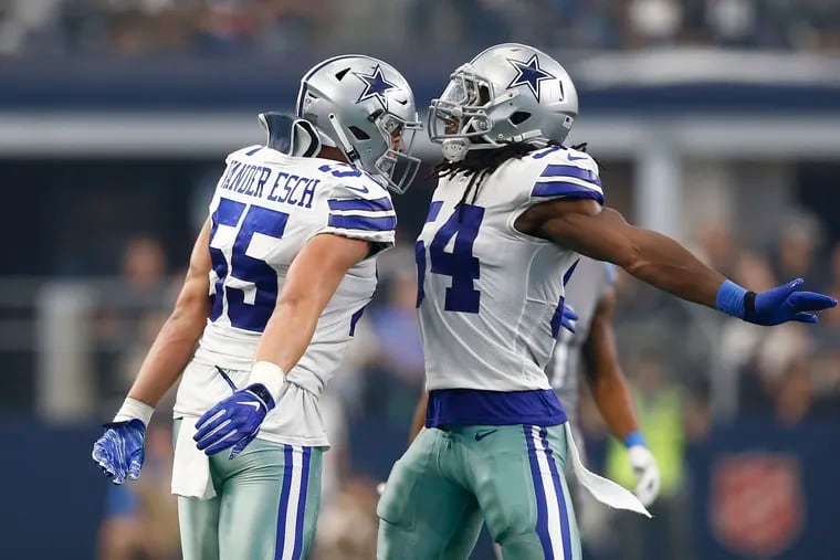 Dallas Cowboys linebackers Leighton Vander Esch (55) and Jaylon Smith (54) celebrate a tackle against the Detroit Lions on September 30, 2018, at AT&T Stadium in Arlington, Texas. (Jim Cowsert/Fort Worth Star-Telegram/TNS)