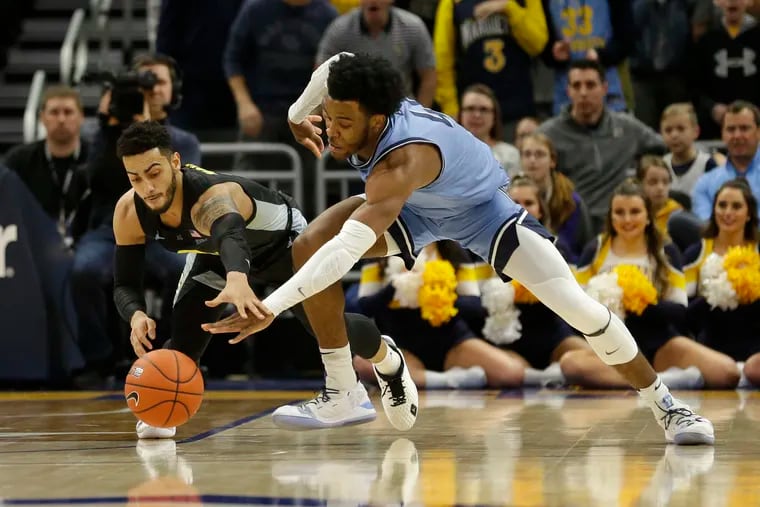 Marquette's Markus Howard, left, and Villanova's Saddiq Bey, right, vie for a loose ball during the  game on Jan. 4.