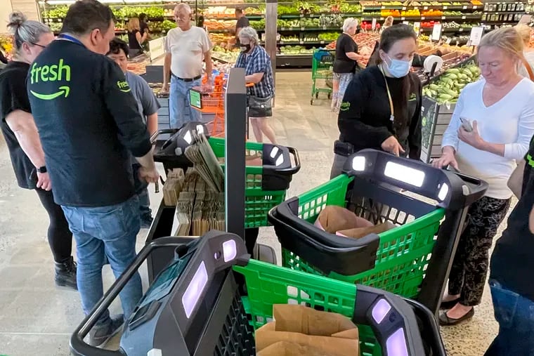 People learn how to use the Amazon Dash Cart at the new Amazon Fresh grocery store off Easton Road in Warrington, Pa. on Thursday, Aug. 5, 2021. It was the grand opening for the store.