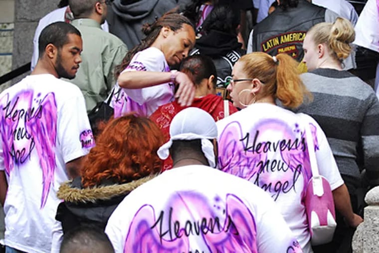 Mourners with airbrushed T-shirts that read "Heaven's New Angel" file into St. Peter's Church for Gina Marie Rosario's funeral Mass today. (Sarah J. Glover / Staff Photographer)