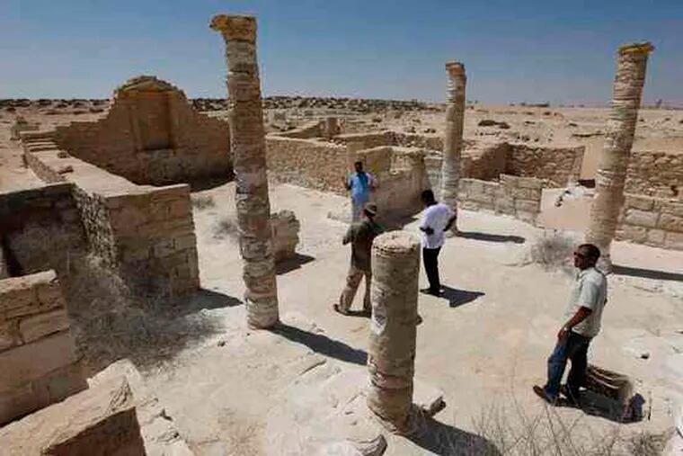 Egyptian antiquities experts walk at a partially restored villa at the ancient city of Leukaspis, which was hidden for centuries after it was nearly wiped out by a fourth-century tsunami.