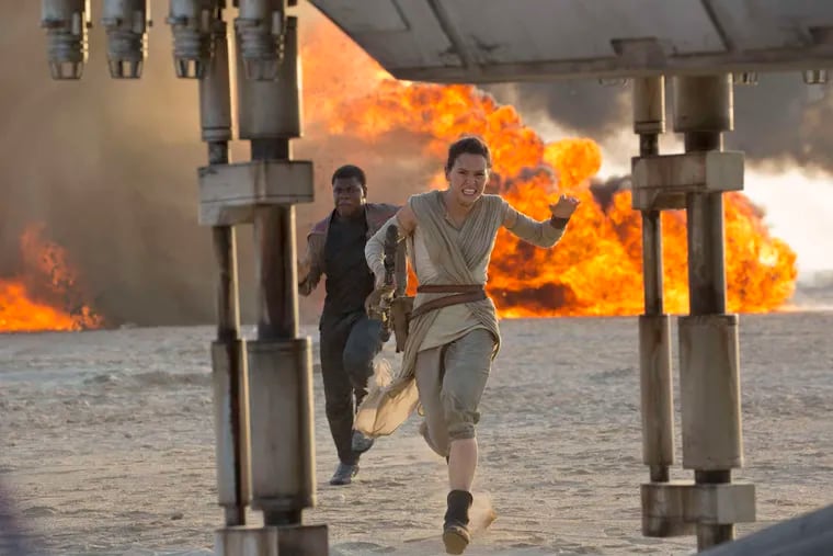 Daisy Ridley and John Boyega in a scene from director J.J. Abrams' blockbuster "Star Wars: The Force Awakens." The film screens as a part of 'Movies @ the Mann' this summer.