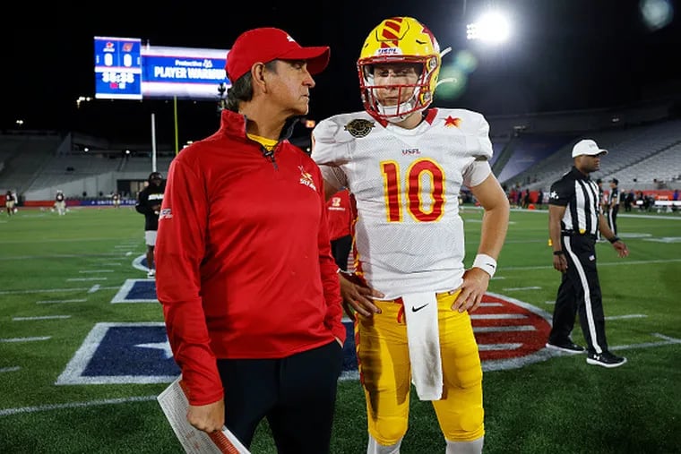Quarterback Case Cookus and head coach Bart Andrus of the Stars talk during warmups before a game against the Michigan Panthers on May 6 in Birmingham, Ala.