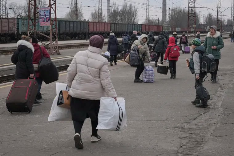 People waiting for a Kyiv bound train spread on a platform in Kostiantynivka, the Donetsk region, eastern Ukraine, Thursday, Feb. 24, 2022. Russia launched a wide-ranging attack on Ukraine on Thursday, hitting cities and bases with airstrikes or shelling, as civilians piled into trains and cars to flee. Ukraine's government said Russian tanks and troops rolled across the border in a “full-scale war” that could rewrite the geopolitical order and whose fallout already reverberated around the world. (AP Photo/Vadim Ghirda)