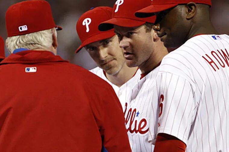 Roy Oswalt convinces Charlie Manuel to leave him in the game during the eighth inning of Game 2. (Ron Cortes / Staff Photographer)