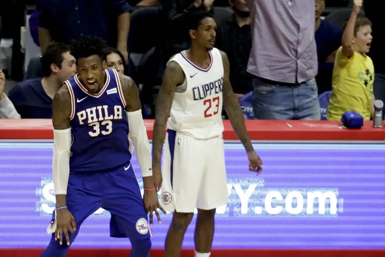 Robert Covington, left, celebrates after making a three-pointer over Los Angeles Clippers guard Lou Williams during the final minute of the Sixers’ 109-105 win Monday night.