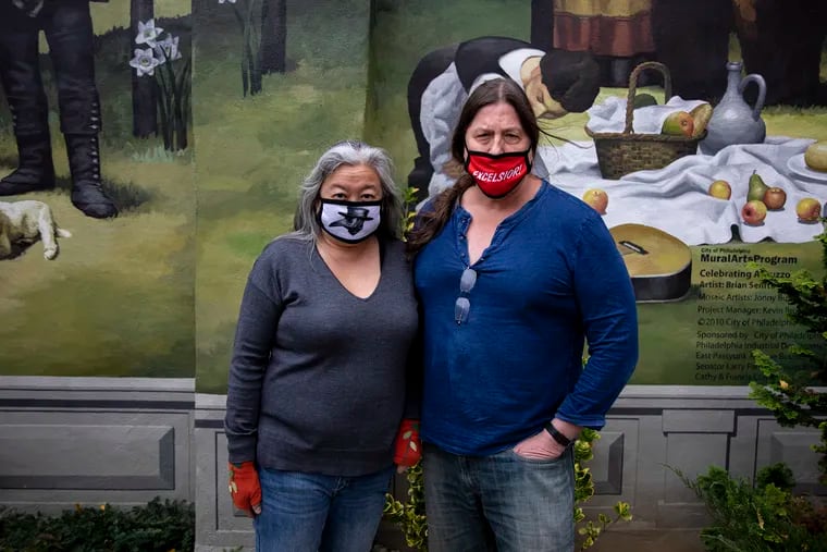Owners Francis Cretarola, (right), and Catherine Lee, (left), pose for a portrait outside of their restaurant, Ristorante Le virtu, on Wednesday, Dec. 2, 2020. The two have closed off the inside of their restaurant since March and have done outside dining and takeout to stay in business.