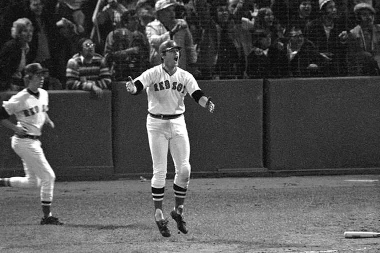 Boston Red Sox hitter Carlton Fisk reacts as he sees his 12th inning home run hit the left foul pole to win the sixth game of the World Series against Cincinnati, Oct. 21, 1975 in Boston's Fenway Park. (Harry Cabluck/AP file)