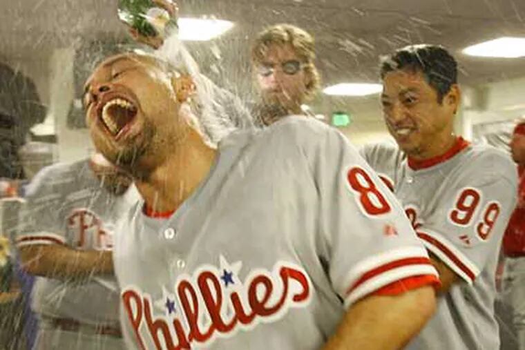 Shane Victorino gets doused with champagne by teammates Jayson Werth and So Taguchi after the Phillies' Game 4 victory on Sunday. (Ron Cortes / Staff photographer) <b><a href="http://www.philly.com/inquirer/photography/sports_photos/Phillies_Advance.html">More photos</a></b>